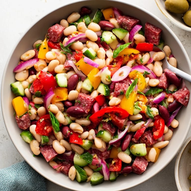 This delicious Mediterranean Dense Bean Salad with salami features hearty beans, olives, and savory salami.