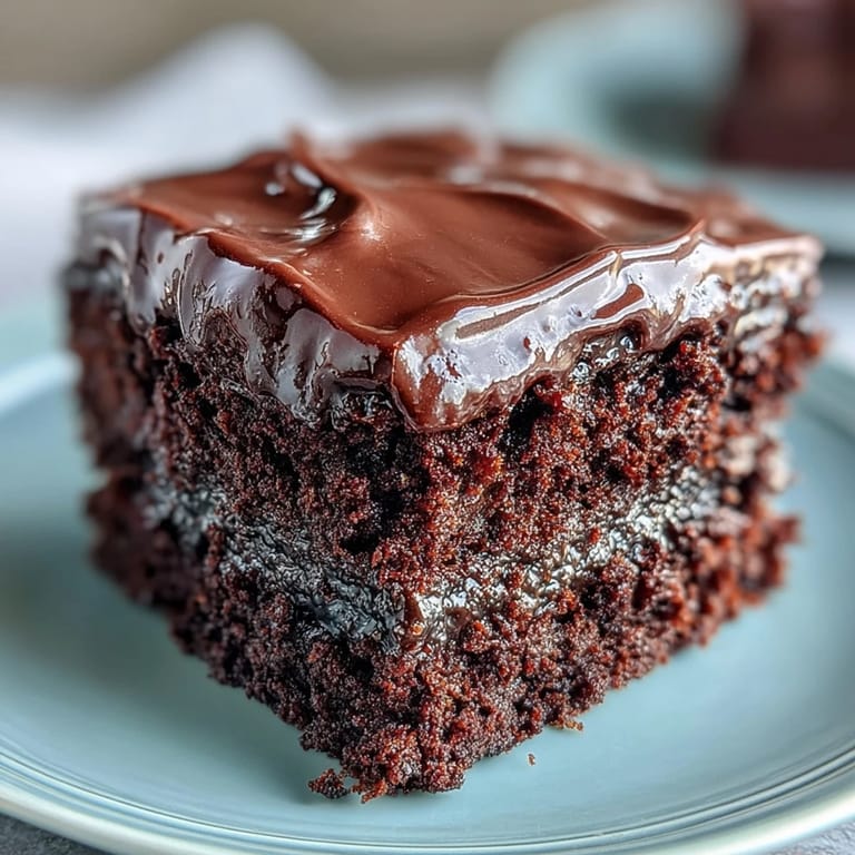 Moist and rich Easy Chocolate Fudge Cake with a glossy chocolate glaze, perfect for celebrations or an indulgent treat.